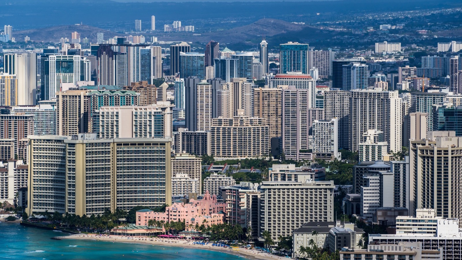 Dense Honolulu skyline rising behind the Waikīkī waterfront
