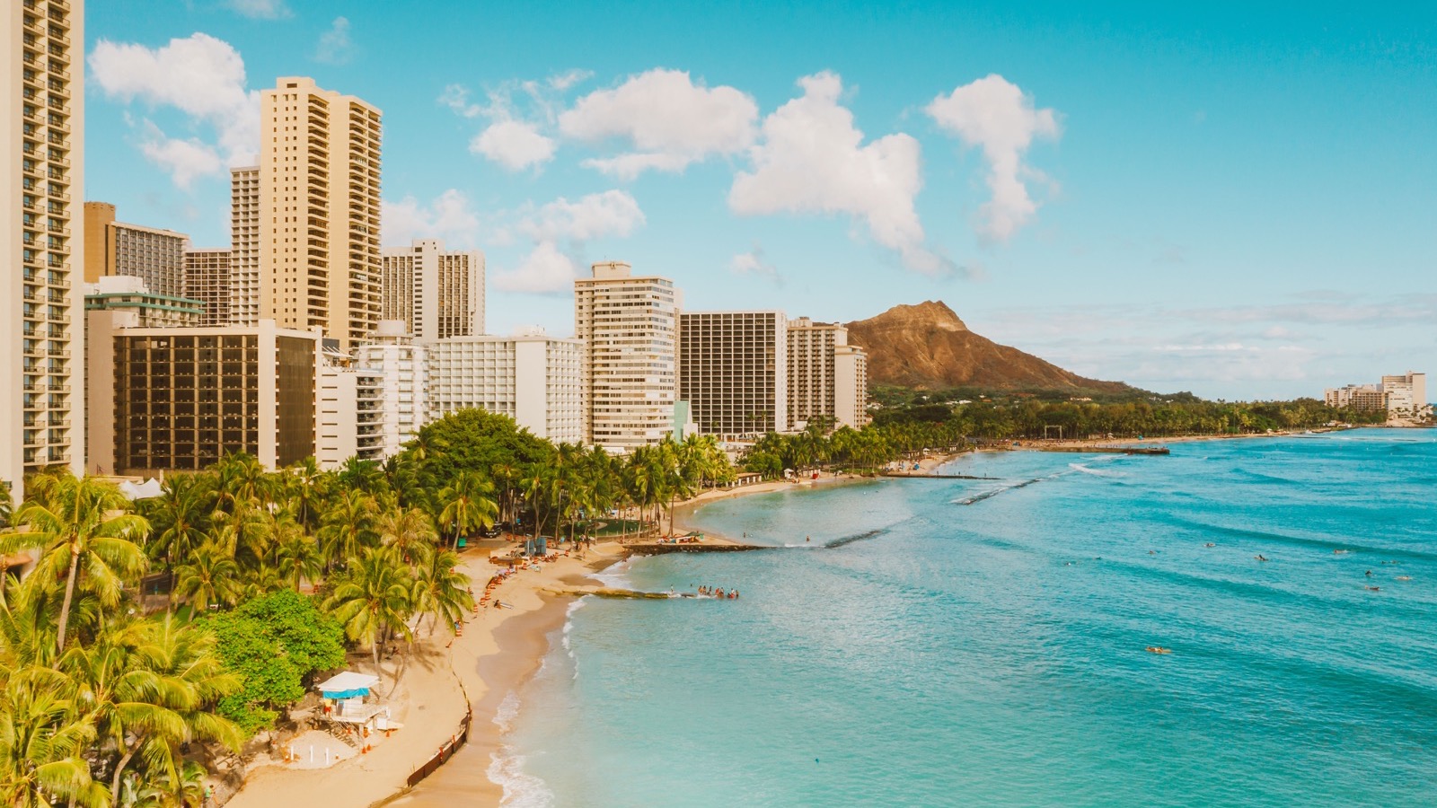 Waikīkī Beach, waterfront hotels, and Diamond Head beneath a blue sky