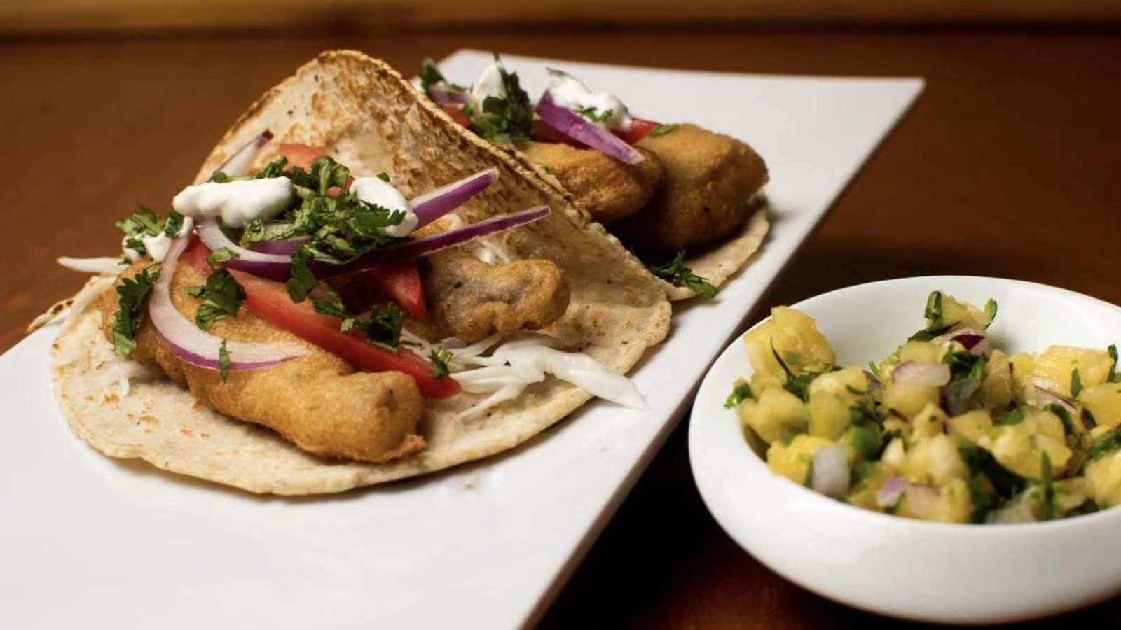 Illustrative stock photo of Baja-style fish tacos with pineapple salsa.