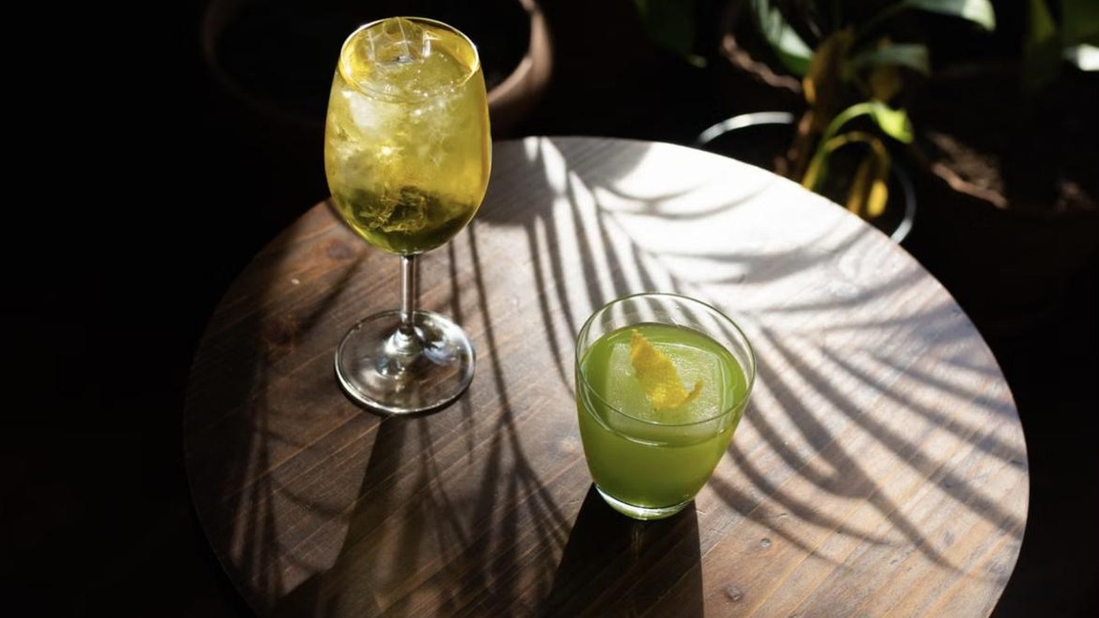 Illustrative stock photo of tropical cocktails with palm shadows.