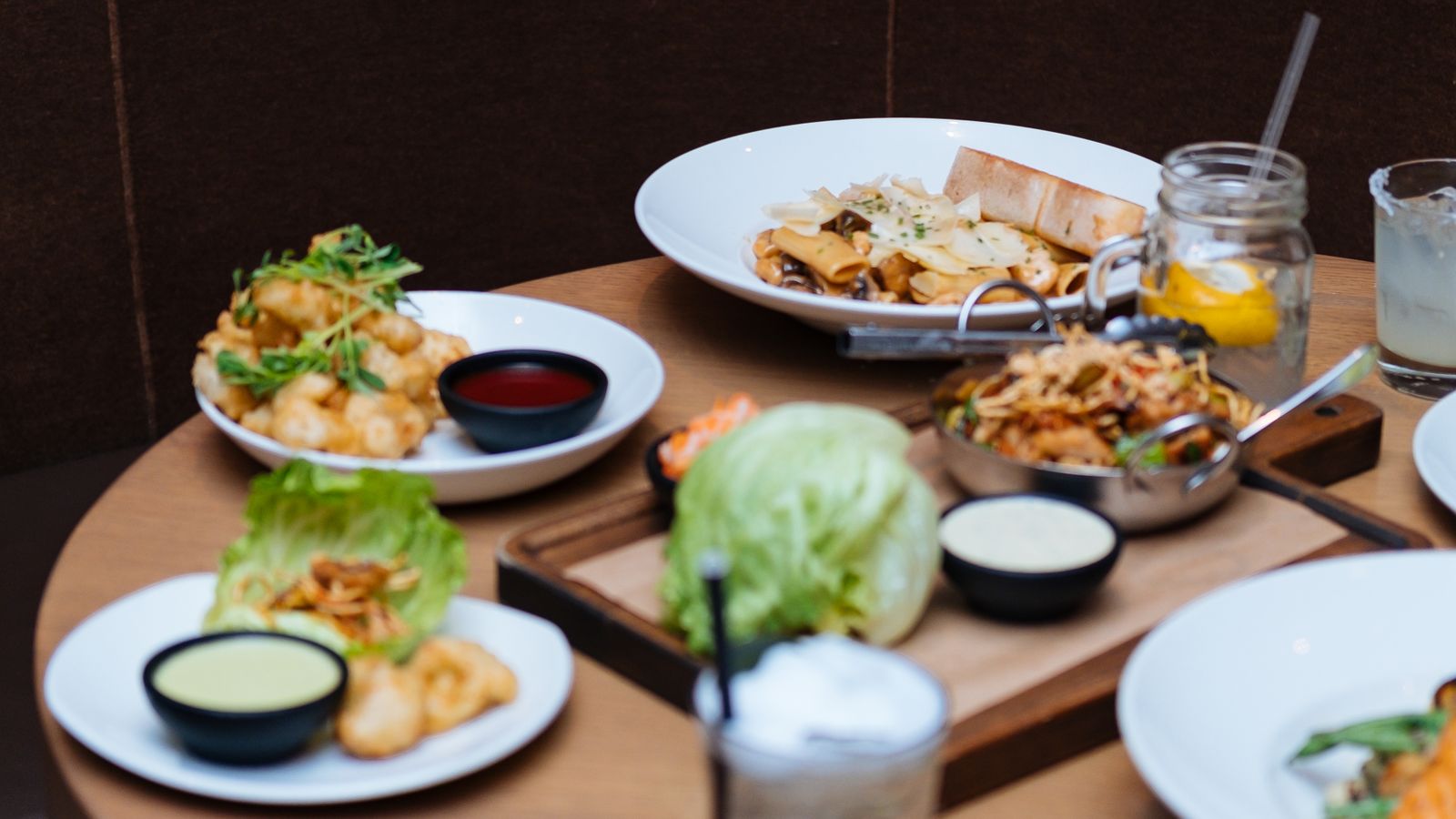 Illustrative stock photo of shared seafood plates and drinks.